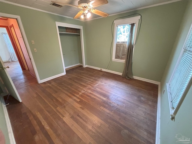 unfurnished bedroom with baseboards, crown molding, visible vents, and dark wood-style flooring