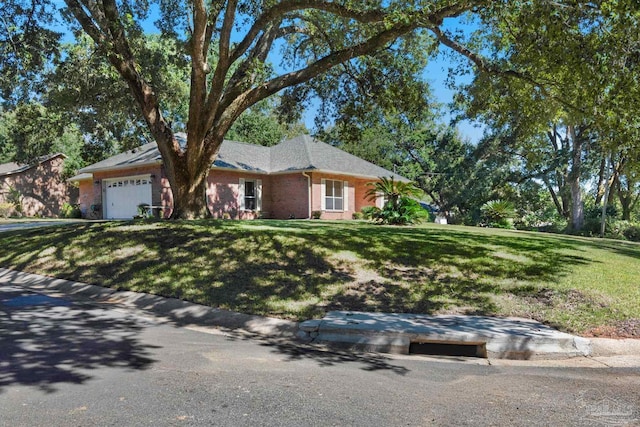 ranch-style home with an attached garage, brick siding, and a front yard