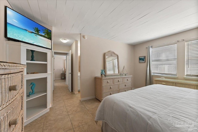 bedroom featuring baseboards, radiator heating unit, wood ceiling, and tile patterned floors