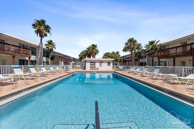 pool featuring a patio area and fence