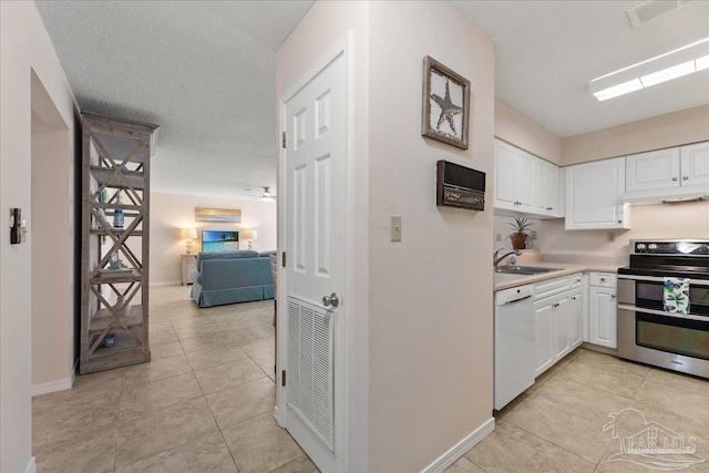 kitchen featuring dishwasher, light countertops, white cabinetry, and double oven range