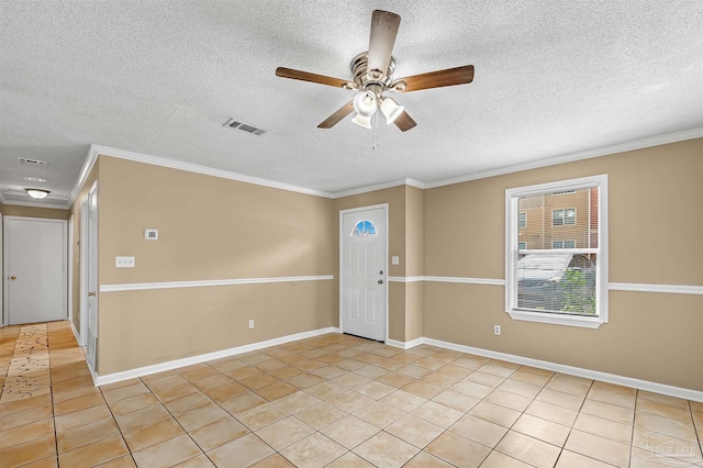 spare room featuring a textured ceiling, light tile patterned floors, ornamental molding, and ceiling fan