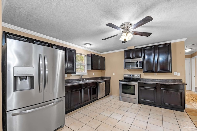 kitchen featuring appliances with stainless steel finishes, light tile patterned flooring, crown molding, ceiling fan, and sink