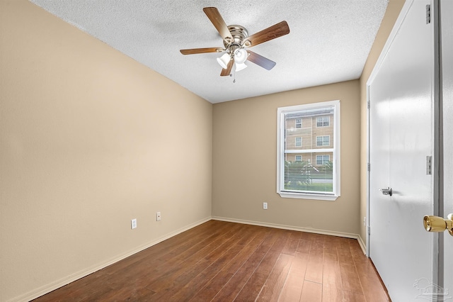 empty room with a textured ceiling, hardwood / wood-style flooring, and ceiling fan