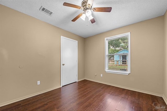 empty room with a textured ceiling, ceiling fan, and dark wood-type flooring