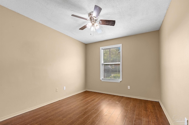 empty room with a textured ceiling, wood-type flooring, and ceiling fan