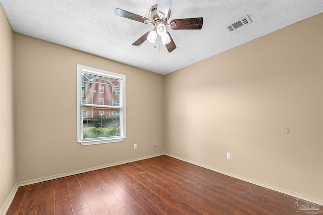 unfurnished room featuring a textured ceiling and dark hardwood / wood-style floors