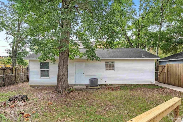 rear view of property with central AC