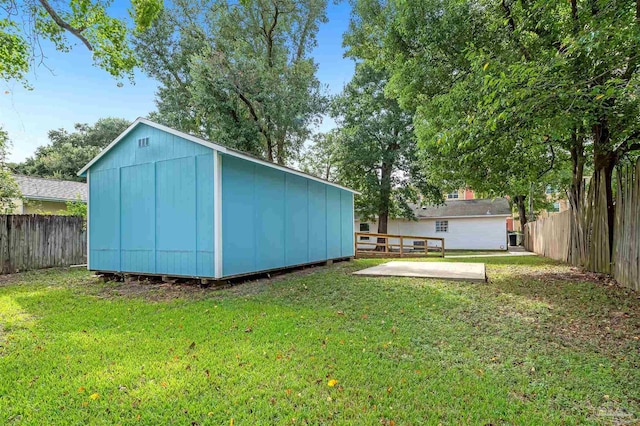 view of yard featuring a patio and a storage unit