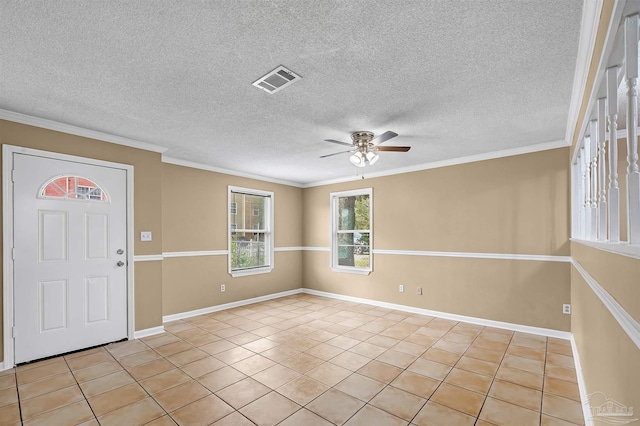 entrance foyer with ceiling fan, a textured ceiling, light tile patterned flooring, and crown molding