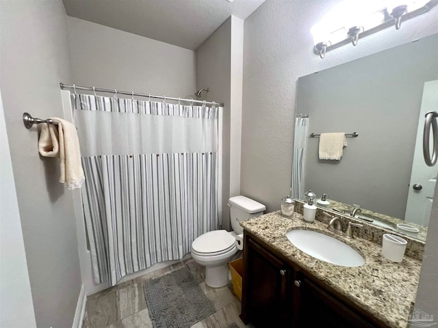 bathroom featuring a shower with curtain, vanity, and toilet