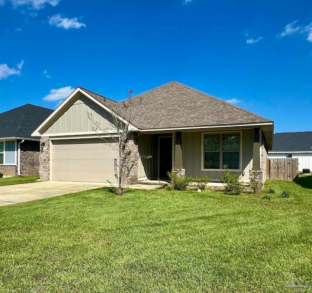 view of front of property featuring a garage and a front lawn