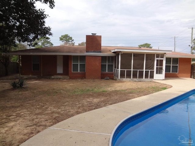 rear view of property with a sunroom