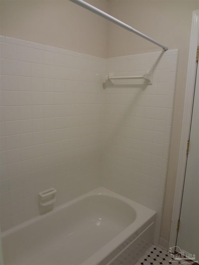 bathroom featuring tile patterned flooring and tiled shower / bath combo