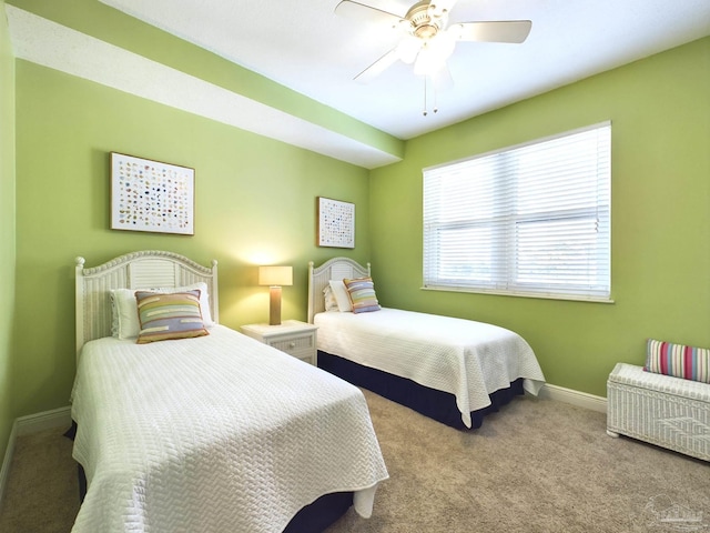 carpeted bedroom with baseboards and ceiling fan