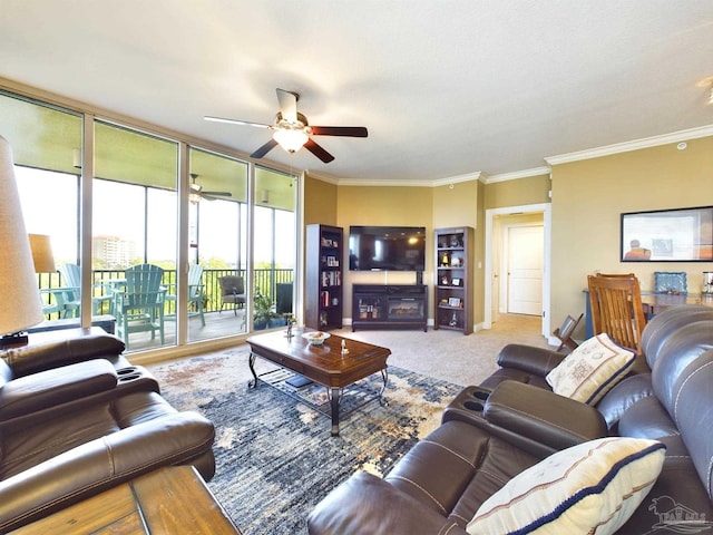carpeted living area featuring crown molding, a ceiling fan, and expansive windows