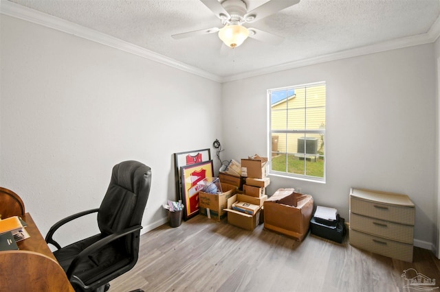 home office featuring ceiling fan, a textured ceiling, light hardwood / wood-style flooring, and crown molding