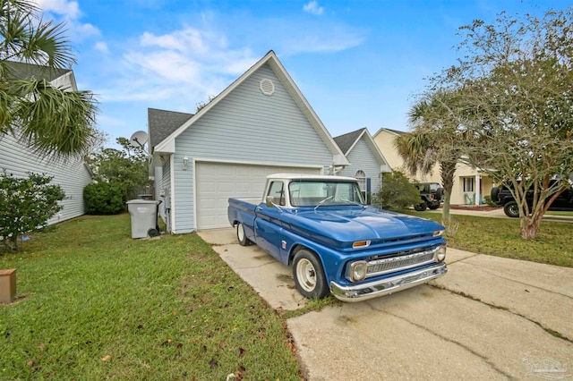 view of side of property featuring a garage and a lawn