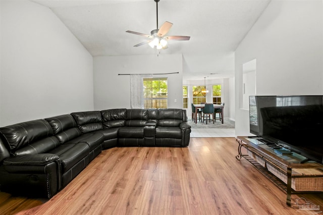 living room featuring lofted ceiling, wood-type flooring, and ceiling fan