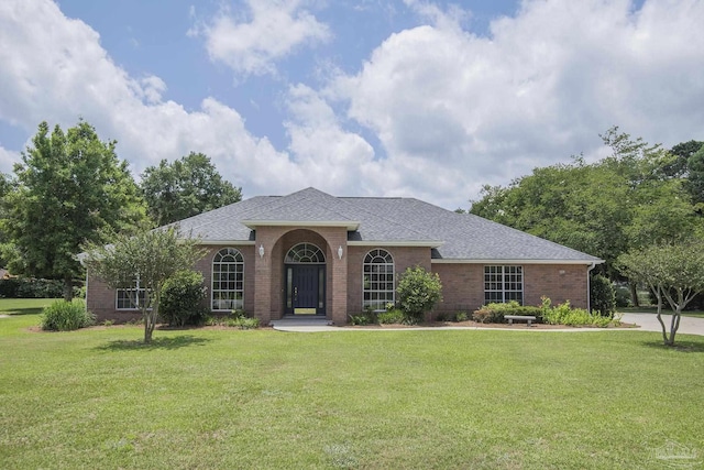 3221 Cobblestone Dr, Pace, FL 32571 - view of front of property with a front yard, brick siding, and roof with shingles