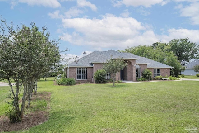 3221 Cobblestone Dr, Pace, FL 32571 - single story home featuring brick siding, a front yard, a chimney, and roof with shingles