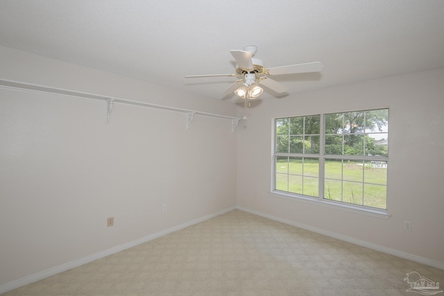 3221 Cobblestone Dr, Pace, FL 32571 - spare room featuring light colored carpet, a ceiling fan, and baseboards