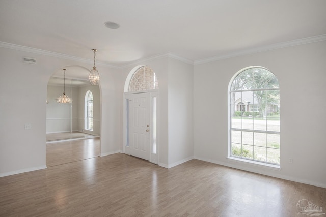 3221 Cobblestone Dr, Pace, FL 32571 - entryway with plenty of natural light, wood finished floors, arched walkways, crown molding, and baseboards