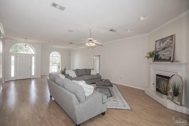 3221 Cobblestone Dr, Pace, FL 32571 - living room with ornamental molding, light wood-style floors, baseboards, a glass covered fireplace, and ceiling fan
