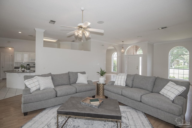 3221 Cobblestone Dr, Pace, FL 32571 - living room featuring a ceiling fan, arched walkways, crown molding, light wood-style flooring, and recessed lighting