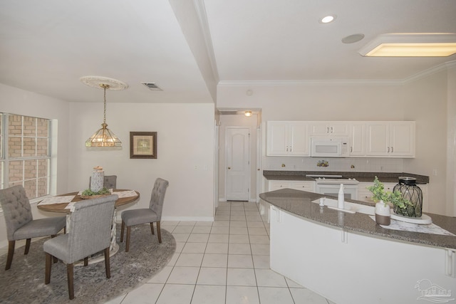 3221 Cobblestone Dr, Pace, FL 32571 - dining area featuring baseboards, light tile patterned floors, and ornamental molding