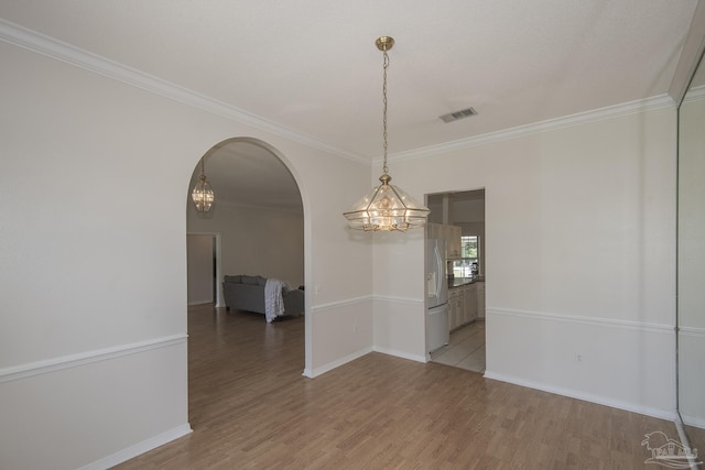 3221 Cobblestone Dr, Pace, FL 32571 - unfurnished room with a chandelier, arched walkways, crown molding, light wood-style flooring, and baseboards
