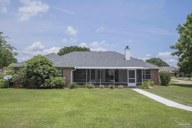 3221 Cobblestone Dr, Pace, FL 32571 - back of property featuring a sunroom, a lawn, brick siding, and a shingled roof