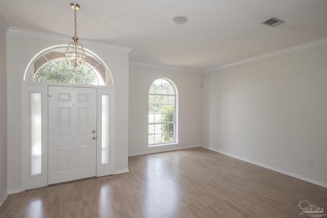 3221 Cobblestone Dr, Pace, FL 32571 - entrance foyer featuring a chandelier, wood finished floors, ornamental molding, and baseboards