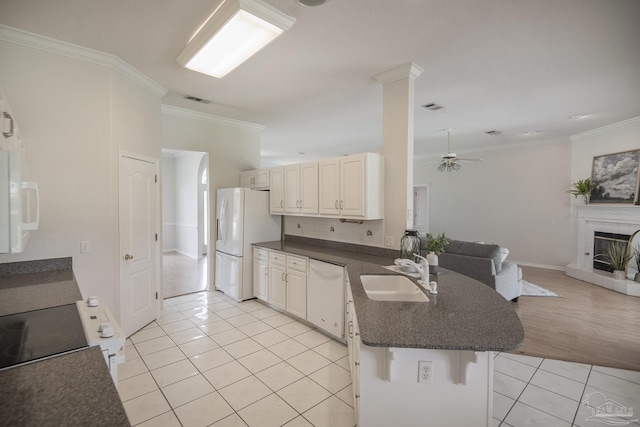 3221 Cobblestone Dr, Pace, FL 32571 - kitchen featuring white appliances, a sink, light tile patterned floors, a peninsula, and open floor plan