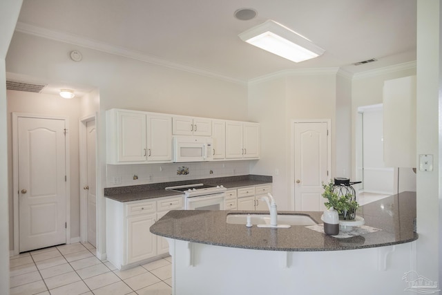 3221 Cobblestone Dr, Pace, FL 32571 - kitchen with white appliances, a sink, ornamental molding, dark stone counters, and white cabinetry