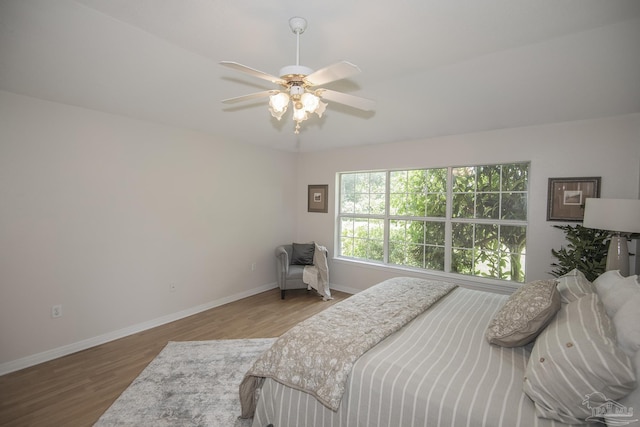 3221 Cobblestone Dr, Pace, FL 32571 - bedroom with wood finished floors, baseboards, and a ceiling fan