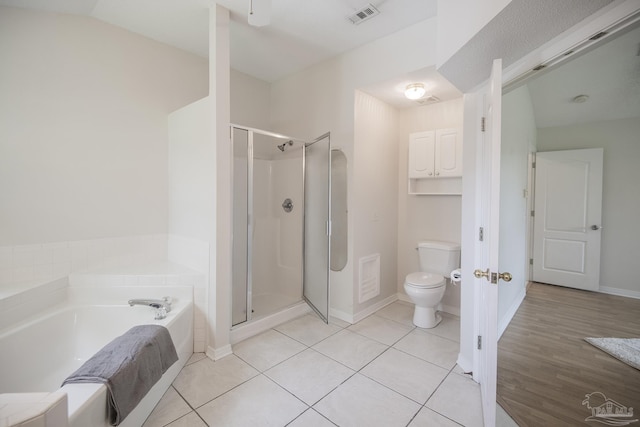 3221 Cobblestone Dr, Pace, FL 32571 - bathroom with a stall shower, toilet, a bath, and baseboards