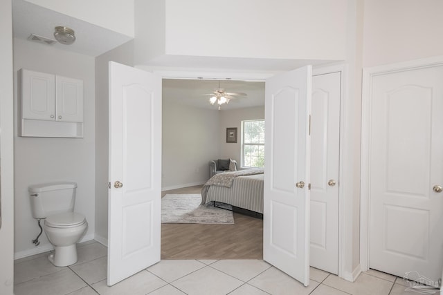 3221 Cobblestone Dr, Pace, FL 32571 - bathroom with ceiling fan, tile patterned floors, toilet, and baseboards