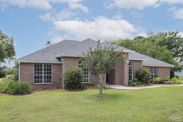 3221 Cobblestone Dr, Pace, FL 32571 - view of front of property featuring brick siding, a front yard, roof with shingles, and a chimney