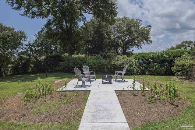 3221 Cobblestone Dr, Pace, FL 32571 - view of green lawn featuring a fire pit and a patio