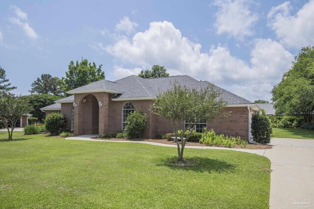 3221 Cobblestone Dr, Pace, FL 32571 - view of front of house featuring brick siding, a front yard, and driveway
