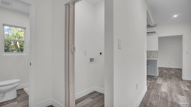 hall featuring light hardwood / wood-style floors and a wall mounted AC