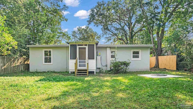 rear view of property with a lawn