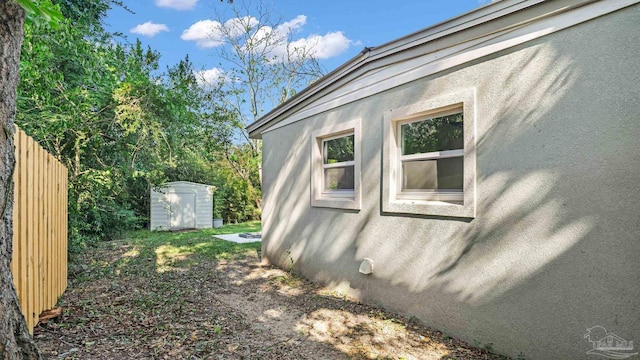 view of side of property with a shed