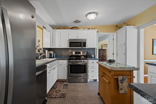 kitchen featuring stainless steel appliances, a sink, visible vents, and white cabinets