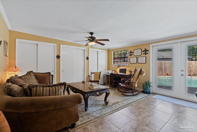 living room featuring a textured ceiling, ceiling fan, french doors, and crown molding