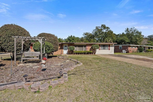 ranch-style home with driveway, a front lawn, brick siding, and a pergola