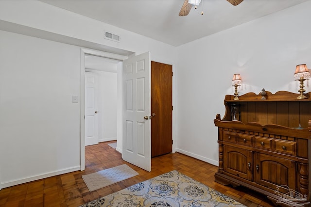 bedroom featuring baseboards, visible vents, and a ceiling fan