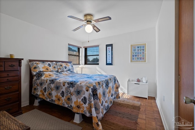 bedroom with a ceiling fan and baseboards