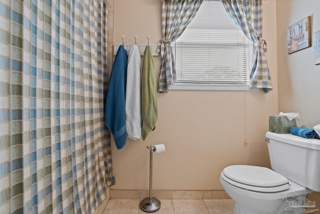 full bath with toilet, curtained shower, and tile patterned floors